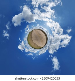 simple little tiny planet without buildings in blue sky with beautiful clouds. Transformation of spherical panorama 360 degrees. Spherical abstract aerial view. Curvature of space.