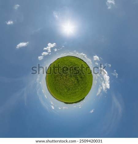 simple little tiny planet without buildings in blue sky with beautiful clouds. Transformation of spherical panorama 360 degrees. Spherical abstract aerial view. Curvature of space.