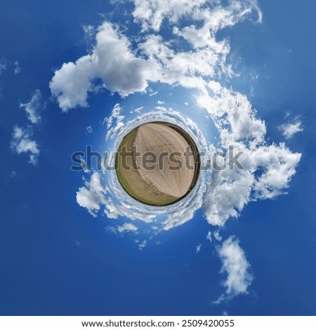 simple little tiny planet without buildings in blue sky with beautiful clouds. Transformation of spherical panorama 360 degrees. Spherical abstract aerial view. Curvature of space.