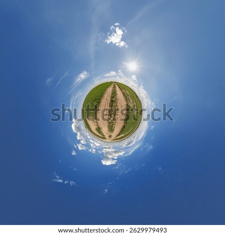 simple little tiny planet without buildings in blue sky with sun and beautiful clouds. Transformation of spherical panorama 360 degrees. Spherical abstract aerial view. Curvature of space.