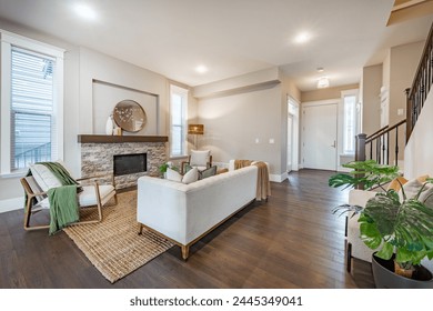 Simple living room interior with bohemian color tones moss green and beige hardwood floor staircase and a stone fireplace