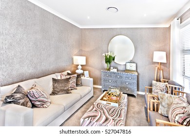 Simple Living Room Interior With Small Space, Including Sofas And Pillows On Wooden Chairs Beside White Window Next To Mirror And Fancy Cupboard