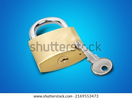 Simple lock and key. Small worn padlock with shiny key. Business data encryption, home security, or other safeguarding metaphor.