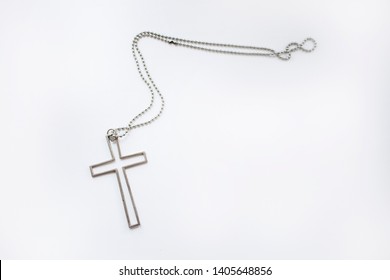 Simple Metallic Cross Necklace On Isolated White Background