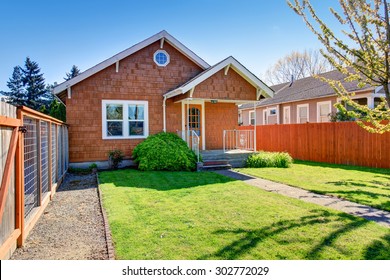 Simple Northwest Home With Green Lawn, And Auburn Exterior.