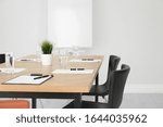 Simple office interior with large table and chairs