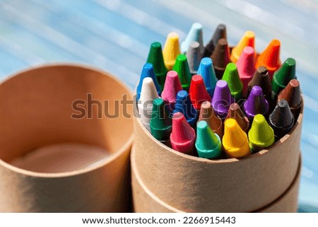 A simple pack, set of colorful wax crayons, multi colored crayon tube container object closeup, detail. Creativity, creative arts and crafts activities abstract concept, symbol, nobody, no people