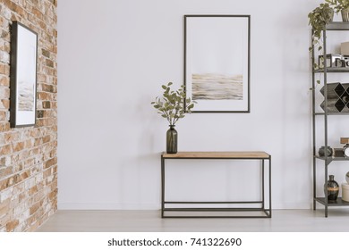 Simple Painting Above Wooden Console Table With Twigs In A Glass Vase In Modern Living Room Interior