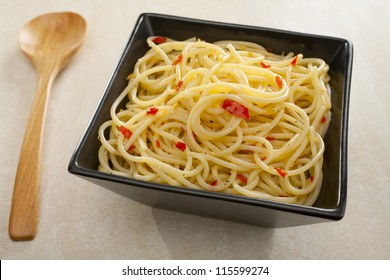 A Simple Pasta Dish, Spaghetti With Garlic, Chili And Olive Oil, Sprinkled With Black Pepper.
