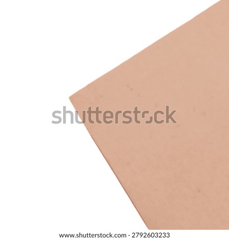 A simple peach colored paper envelope with one corner slightly lifted, isolated on clean background