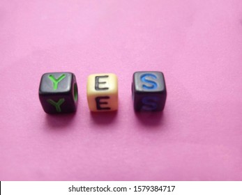 Simple  photo for Yes or accept, made from black plastic alphabet cube bead