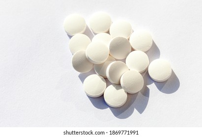 Simple plain white pills heap, medication, tablets stacked on white background, pharmaceutical industry, prescription abstract Drugs medical supplies conceptual, white background, objects set, nobody