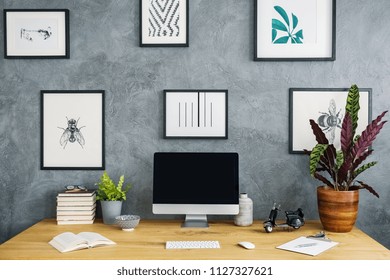 Simple Posters Hanging On Grey Raw Wall In Study Corner Living Room Interior With Wooden Desk With Mockup Monitor, Fresh Plants And Books