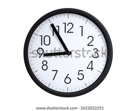 Simple round wall clock with black frame and white face, showing the time exactly at 08:55 or 20:55. Representing time precision in concepts of deadlines.