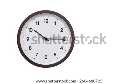 A simple round wall clock with a dark brown frame and a white face displaying 10.15 or 22.15. Isolated on a white background, perfect for time-related concepts, deadlines, and schedule themes.