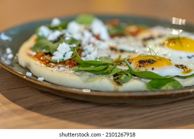 A simple savory breakfast, Cilbir (Turkish Eggs) is perfectly poached eggs, served over a delicious garlicky yogurt, and finished with a warm spicy butter or olive oil sauce  - Shutterstock ID 2101267918