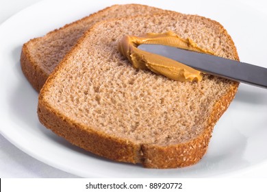 Simple setting of peanut butter on wheat bread in the making - Powered by Shutterstock