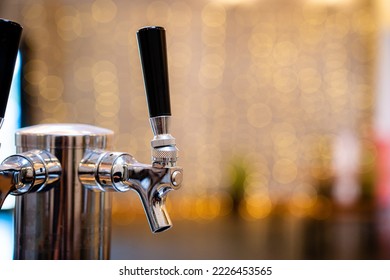 Simple Silver Steel Beer Tap At Brewery Pub With No People And Yellow Twinkle Blurred Background