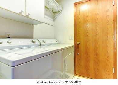 Simple Small Laundry Area With Cabinet, Washer And Dryer