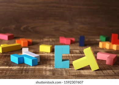 Simple Solutions To Complex Problems. Strategy In Business. Wooden Tetris Cubes On A Dark Background As A Puzzle Symbol. The Challenge With A Difficult Solution