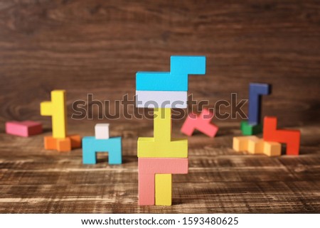 Simple solutions to complex problems. Strategy in business. Wooden Tetris cubes on a dark background as a puzzle symbol. The challenge with a difficult solution