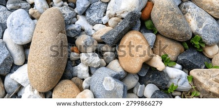 Simple stack of three balanced river stones, creating an iconic zen symbol for holistic medicine and physical alignment