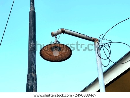 Image, Stock Photo Street lamp in front of a two-tone house wall at the edge of a parking area