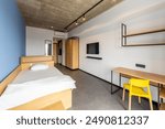 Simple student-style dorm bedroom. Hostel dormitory room. Campus