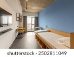 Simple student-style dorm bedroom. Hostel dormitory room. Campus