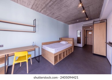 Simple student-style dorm bedroom. Hostel dormitory room. Campus - Powered by Shutterstock