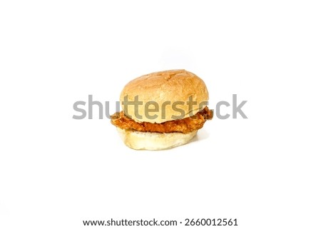 A simple, studio-shot image featuring a plain fried chicken slider or mini chicken sandwich on a white background.