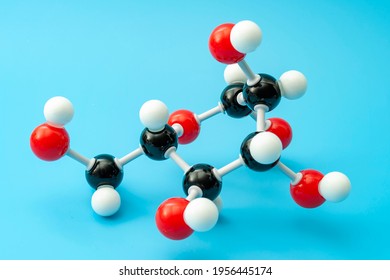 Simple Sugars, Diabetes Awareness And Chemical Structure Of Carbohydrates Concept With Plastic Model Of The Glucose Molecule Isolated On Blue Background