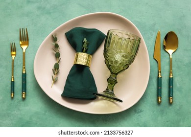 Simple table setting on green background - Shutterstock ID 2133756327