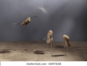 Simple Things - Peanut Man Flying with Dandelion Blowball Umbrella - Powered by Shutterstock