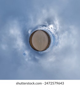simple tiny planet without buildings in blue sky with beautiful clouds. Transformation of spherical panorama 360 degrees. Spherical abstract aerial view. Curvature of space.