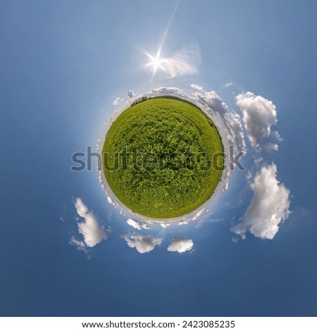 simple tiny planet without buildings in blue sky with beautiful clouds. Transformation of spherical panorama 360 degrees. Spherical abstract aerial view. Curvature of space.