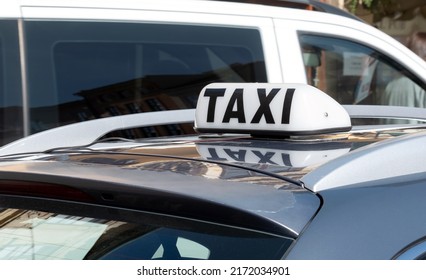 Simple traditional taxi cab car roof top sign, white object up close, detail, closeup, nobody, daytime Taxi service business, city transportation concept, no people, taxicab symbol, urban transport - Shutterstock ID 2172034901