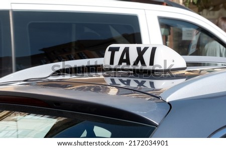 Simple traditional taxi cab car roof top sign, white object up close, detail, closeup, nobody, daytime Taxi service business, city transportation concept, no people, taxicab symbol, urban transport