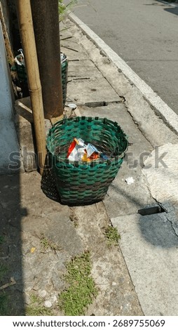 A simple trash bin is a basic container used for collecting waste. It is usually made from plastic or metal and has an open top or a basic lid. The design is straightforward, without any advanced 