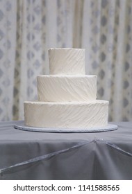 Simple Undecorated Wedding Cake Iced With White Icing