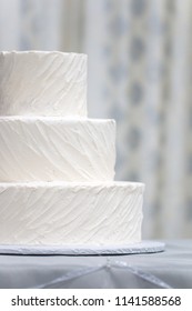 Simple Undecorated Wedding Cake Iced With White Icing