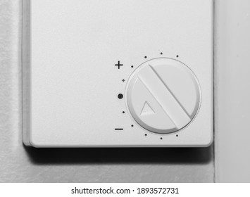 Simple Wall Mounted White Thermostat Dial For Adjusting Room Temperature. Close Up.