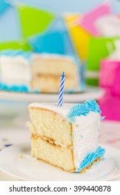 Simple white Birthday cake slice with white and blue icing.