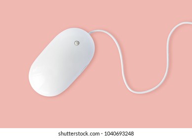Простая белая компьютерная мышь с шнуром, изолированным на пастельном розовом фоне, минимальный стиль