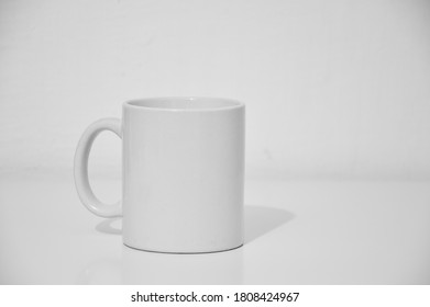 Simple white mug behind white background - Shutterstock ID 1808424967