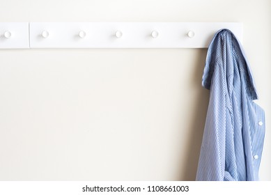 Simple White Wall Coat Hanger With A Hanging Shirt