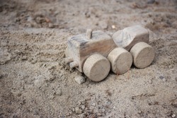 Simple Wooden Digger Toy In A Kid's School Playground Sandbox Sandpit