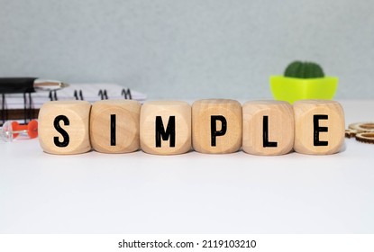 SIMPLE word made with building blocks isolated on white.