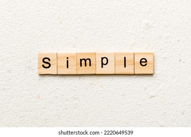simple word written on wood block. simple text on table, concept.