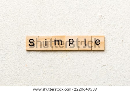 simple word written on wood block. simple text on table, concept.
